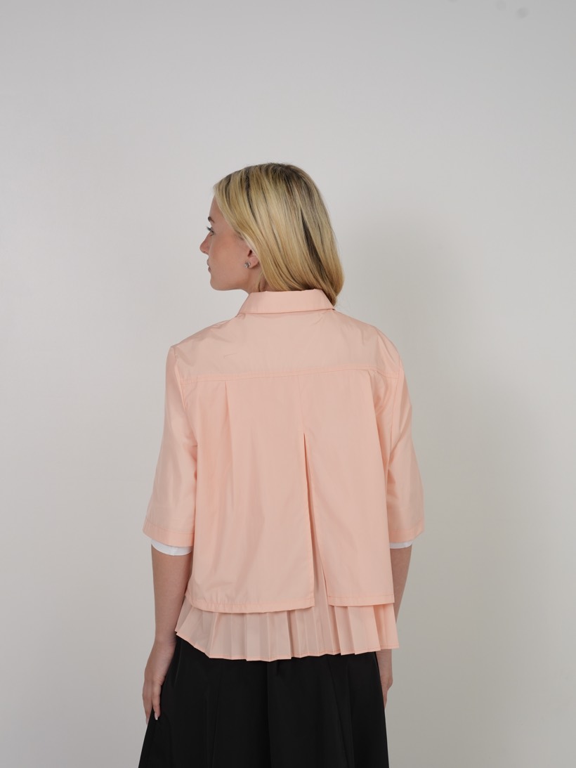 Peach blouse with pleated hem, back view